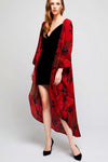 Model wearing long black crepe kimono with red leaf prints facing front
